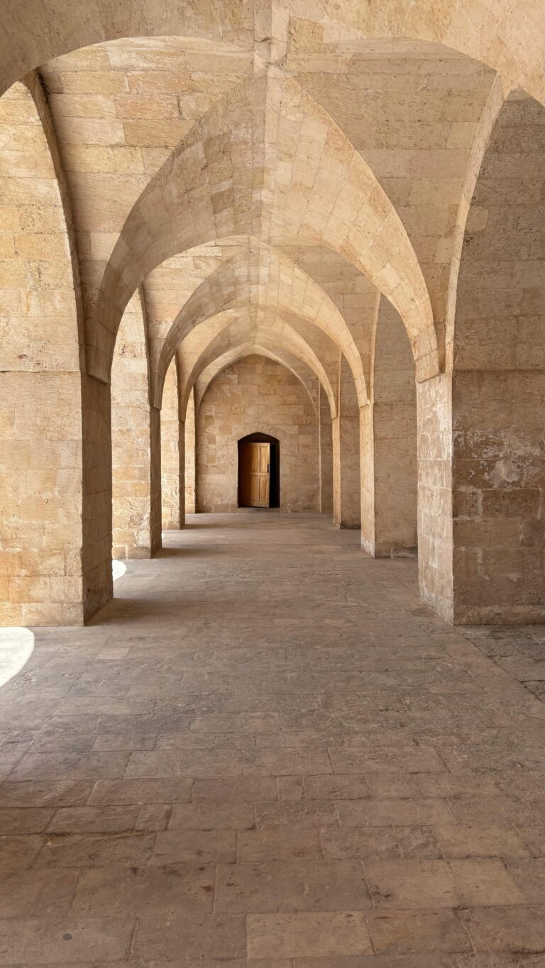 Long stone corridor with stunning arched ceilings and rustic texture.